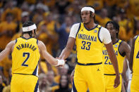 Indiana Pacers center Myles Turner (33) celebrates with teammate guard Andrew Nembhard (2) during the first half of Game 6 against the New York Knicks in an NBA basketball second-round playoff series, Friday, May 17, 2024, in Indianapolis. (AP Photo/Michael Conroy)