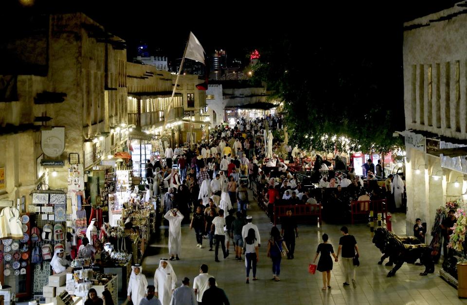 FILE - People walk at Souq Waqif in Doha, Qatar, Monday, May 13, 2019. (AP Photo/Kamran Jebreili, File)