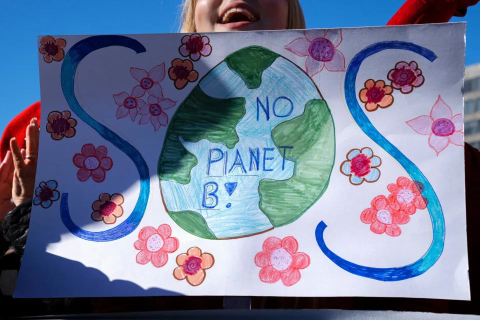 Grace Suzanna Mashensic, 16, of Columbus, Ohio, cheers for Jane Fonda as she speaks during "Fire drill Fridays," a climate change rally, Friday, Dec. 2, 2022, in Washington.