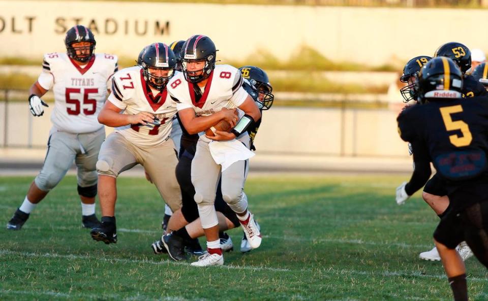 Nipomo quarterback Griffin Groshart (8) dodges defenders. San Luis Obispo beat Nipomo 38-7 in a nonleague game at San Luis Obispo High School’s Holt Field stadium, Aug. 18, 2023.