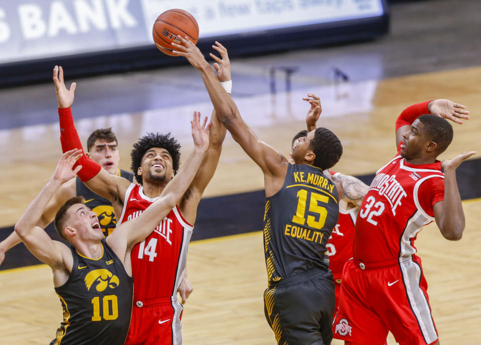 Iowa forward Keegan Murray (15) attempts a shot under pressure from Ohio State forwards Justice Sueing (14) and E.J. Liddell (32) during an NCAA college basketball game in Iowa City, Iowa, Thursday, Feb. 4, 2021. (Rebecca F. Miller/The Gazette via AP)