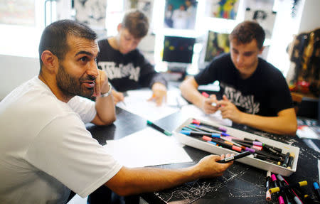 Graffiti artist Ibo Omari gives an interview in his shop in Berlin, Germany August 18, 2017. REUTERS/Hannibal Hanschke