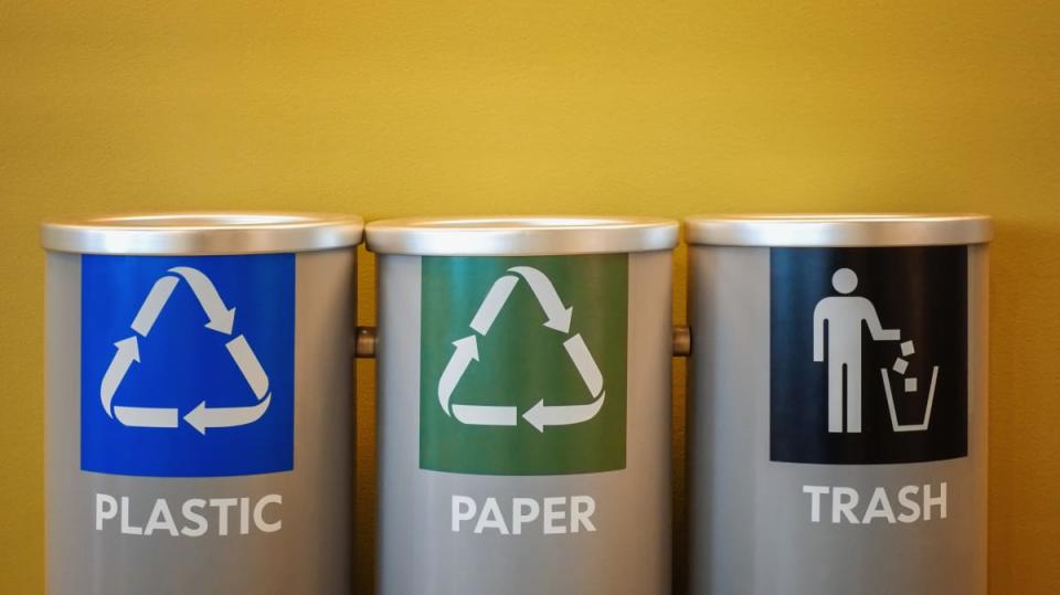 Recycling bins on yellow background