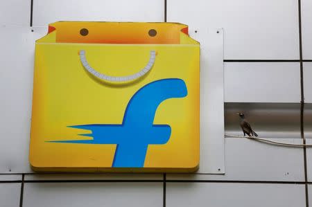 A Common myna sits next to the logo of India's e-commerce firm Flipkart installed on the company's office in Bengaluru, April 12, 2018. REUTERS/Abhishek N. Chinnappa
