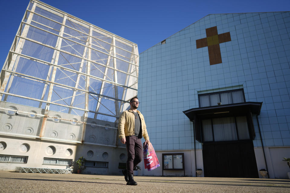 Tiziano Fabi Braga, coordinator of the Mosaiko Christian LGBTQ+ group walks past the Santa Margherita Maria Alacoque parish church on the outskirts of Rome, Tuesday, Dec. 19, 2023. Pope Francis’ authorization for Catholic priests to offer blessings to same-sex couples is in many ways a de facto recognition of what has been going on in some European parishes for years. But Francis’ decision to officially spell out his approval could send a message of tolerance to places where gay rights are far less evolved. (AP Photo/Andrew Medichini)