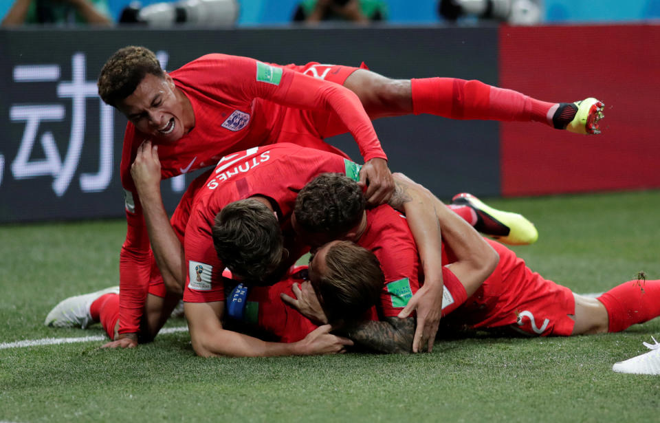 <p>Harry Kane is covered by his team-mates after giving England the lead </p>