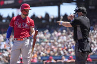 Philadelphia Phillies' Bryce Harper, left, looks at home plate umpire Greg Gibson, right, as he is called out on strikes during the sixth inning against the San Francisco Giants during a baseball game Sunday, June 20, 2021, in San Francisco. (AP Photo/Tony Avelar)