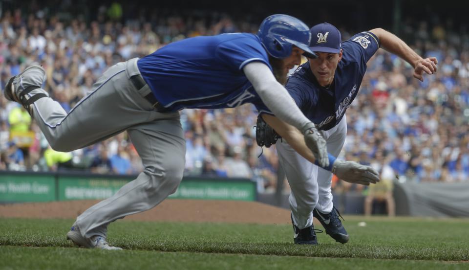 Brewers pitcher Brent Suter did everything in his power to tag out Alex Gordon. (AP Photo)