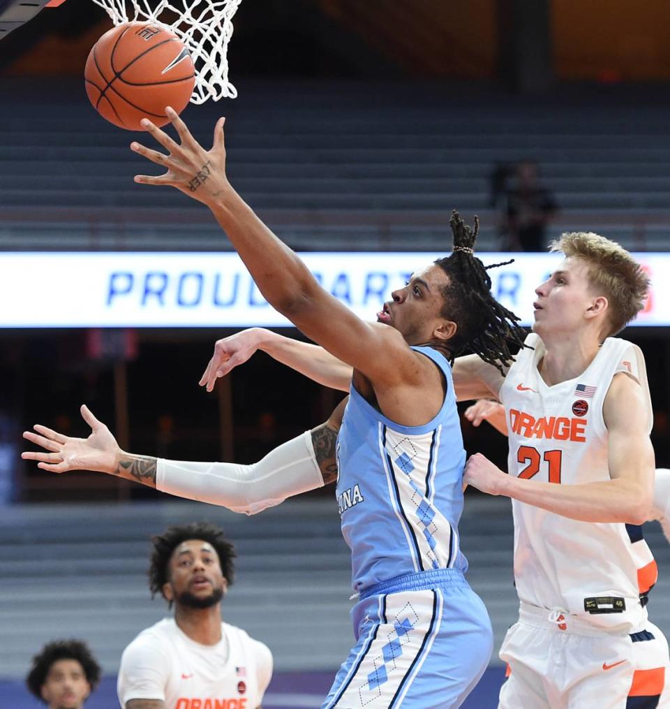 North Carolina Tar Heels forward Armando Bacot (5) with the left hand past Syracuse Orange forward Marek Dolezaj (21) in a game between Syracuse and North Carolina at the Carrier Dome in Syracuse N.Y. March 1, 2021. Dennis Nett | dnett@syracuse.com