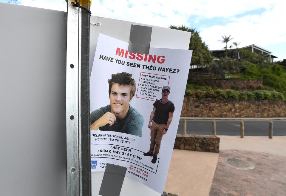 Pictured on a Byron Bay beach is a missing persons flyer for Theo Hayez. Source: AAP