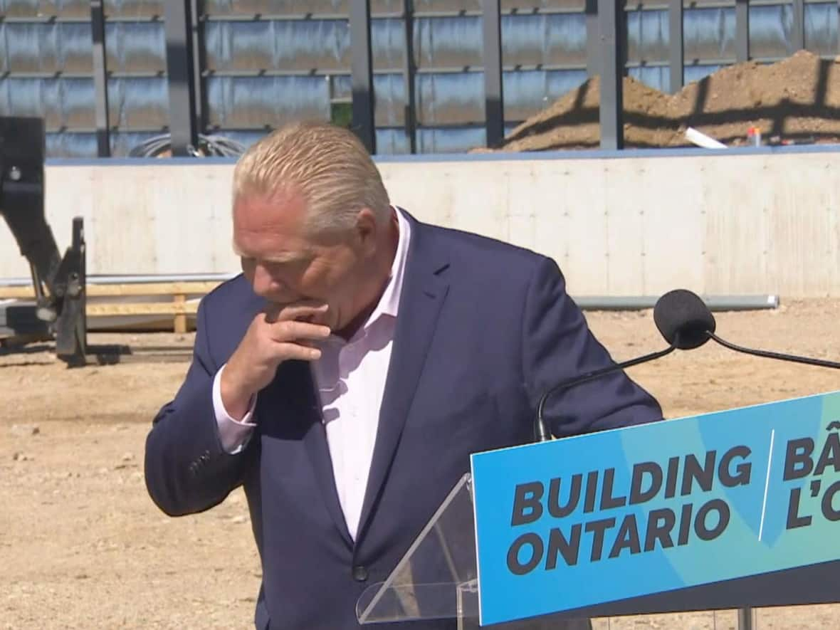 Ontario Premier Doug Ford coughs after swallowing a bee while talking about health care on Friday. (CBC - image credit)