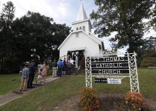 People stand in line to attend a vigil for the deceased held at St. Thomas Catholic Church in Lexington, Miss., for Sister Margaret Held and Sister Paula Merrill, Sunday, Aug. 28, 2016. The two nuns, from different orders, were found murdered in the Durant, Miss., house they rented, on Thursday. Over 300 people attended the service. Although authorities have arrested a suspect, they speculate on the motive of the deaths of the two nurse practitioners, who worked the poor in a clinic in Lexington. (AP Photo/Rogelio V. Solis)