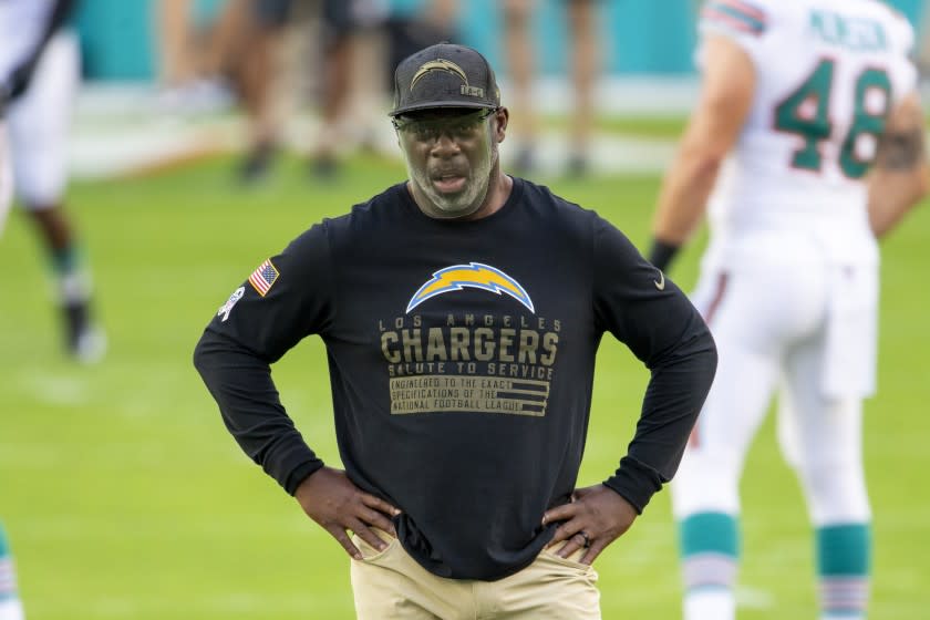 Los Angeles Chargers head coach Anthony Lynn wears a face shield and a Salute to Service shirt.