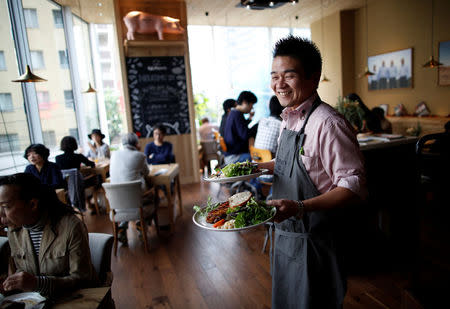 A staff member prepares for serve a pork steak at HyLife Pork Table, a pork dish restaurant operated by HyLife, a Canadian pig farmer and pork processor, at Daikanyama district in Tokyo, Japan October 31, 2016. REUTERS/Issei Kato