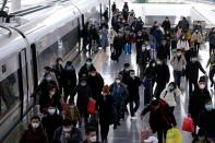 Passengers wearing masks are seen arrival at the Shanghai railway station in Shanghai