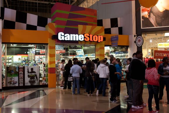 Shoppers lining up outside a GameStop before a midnight release party.