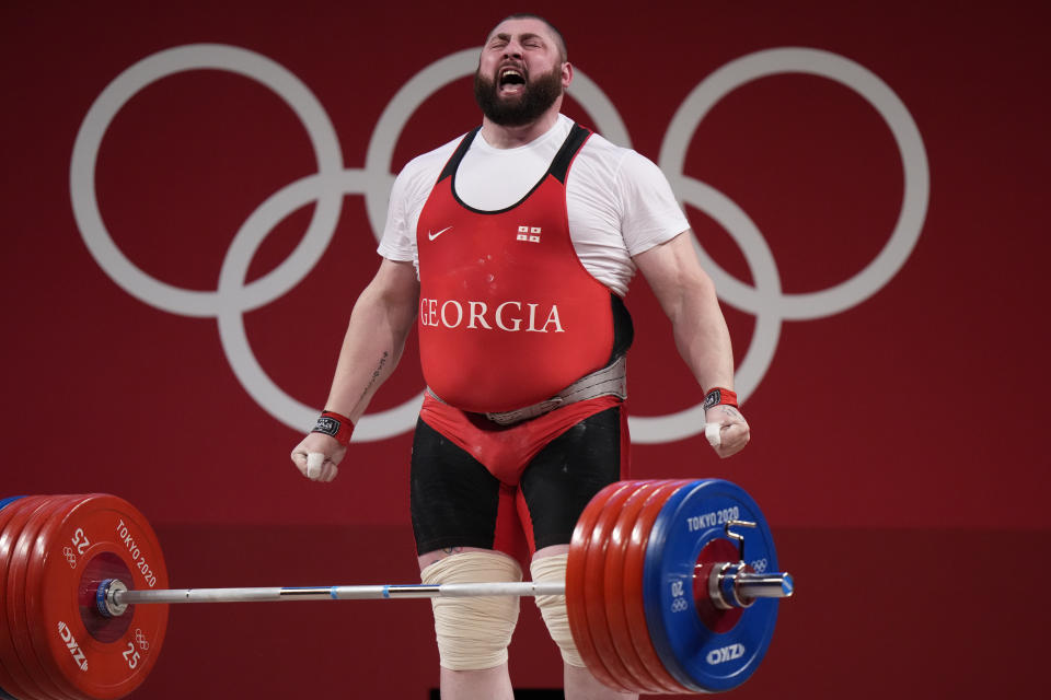 Lasha Talakhadze of Georgia celebrates after winning gold in the men's +109kg weightlifting event, at the 2020 Summer Olympics, Wednesday, Aug. 4, 2021, in Tokyo, Japan. (AP Photo/Luca Bruno)