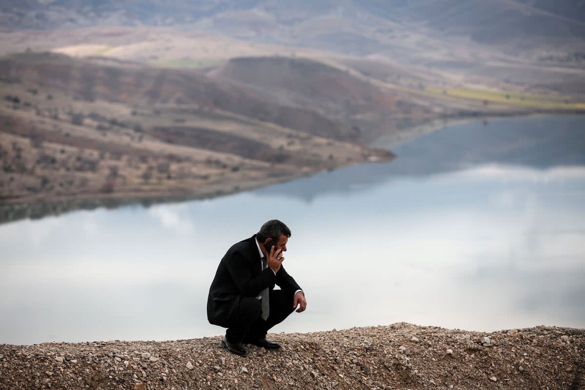 A relative of missing miners, talks on his phone next to the Copler gold mine near Ilic village in eastern Turkey (Ugur Yildirim/Dia images via AP) (AP)