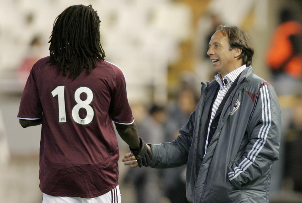 FILE - In this March 20, 2007, file photo, Colorado Rapids coach Fernando Clavijo, right, gives instructions to his player Ugo Ihemelu, left, during a friendly soccer match against Valencia at the Mestalla Stadium in Valencia, Spain. Clavijo, a surprise starter for the 1994 U.S. World Cup team who went on to a coaching and management career in Major League Soccer, died Friday, Feb. 8, 2019, at his home in Fort Lauderdale, Fla., from multiple myeloma. He was 63. (AP Photo/Fernando Bustamante, File)