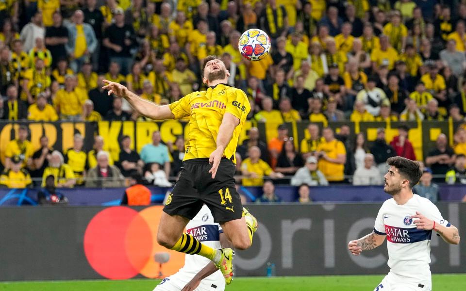 Dortmund's Niclas Fuellkrug, top, jumps for a header during the Champions League semifinal first leg soccer match