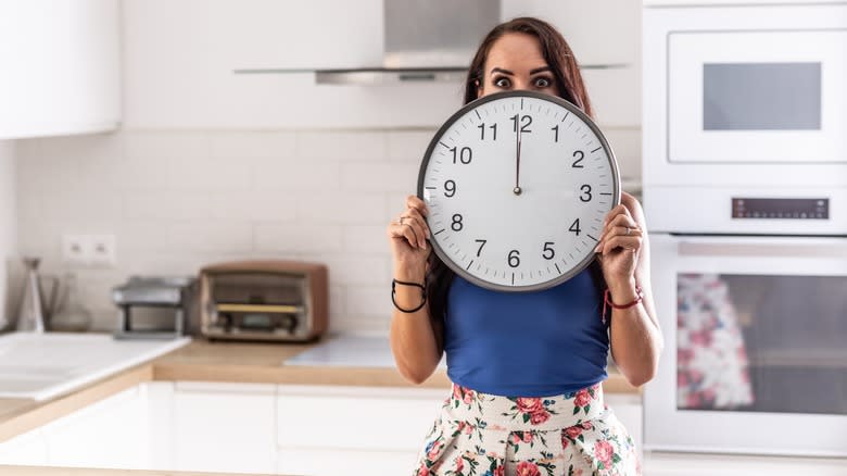 Woman holding a clock