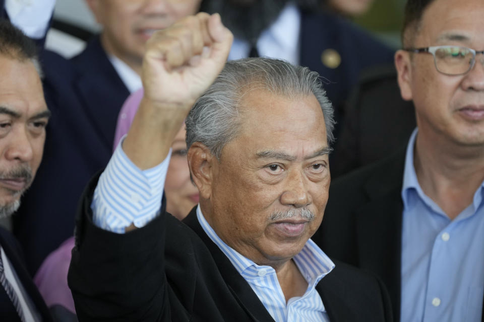 Malaysia's former Prime Minister Muhyiddin Yassin poses for media outside courthouse, after charged with corruption and money laundering, in Kuala Lumpur, Malaysia, Friday, March 10, 2023. Muhyiddin has been charged with corruption and money laundering, making him Malaysia's second ex-leader to be indicted after leaving office. Muhyiddin pleaded innocent Friday to four charges of corruption and two charges of money laundering. (AP Photo/Vincent Thian)