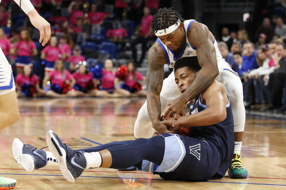 Villanova guard Justin Moore, bottom, tries to keep the ball from DePaul guard Markese Jacobs during the first half of an NCAA college basketball game Wednesday, Feb. 19, 2020, in Chicago. (AP Photo/Jeff Haynes)