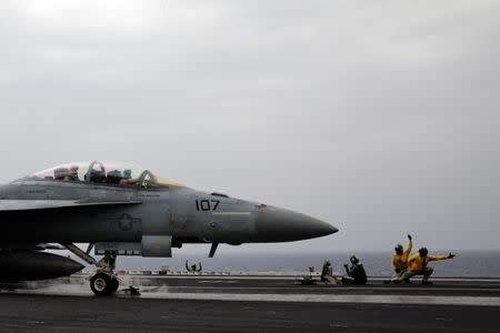 Dodging planes and a taste of home: life on a U.S. aircraft carrier