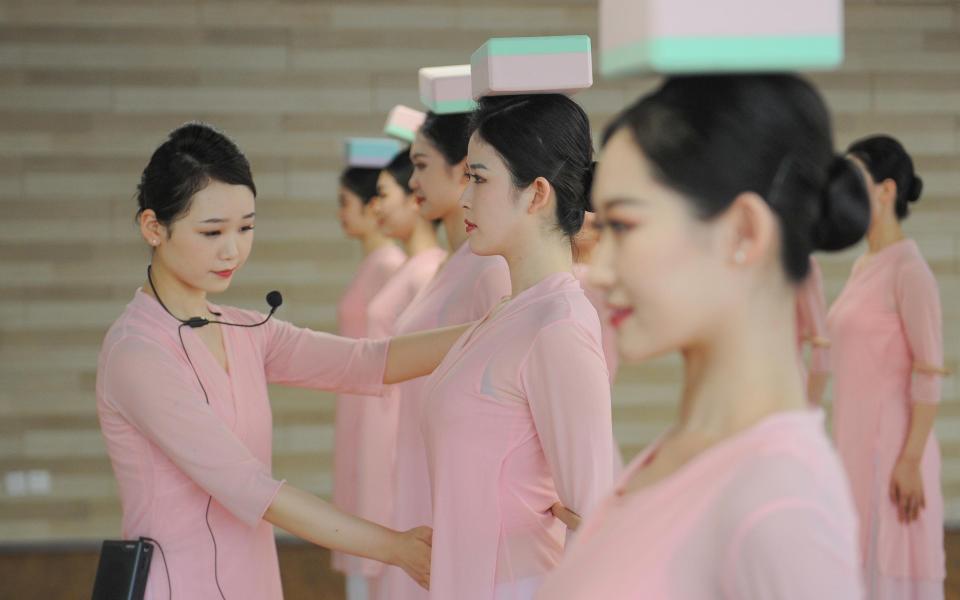 Flight attendants of Zhejiang Loong Airlines undergo rigorous posture training - Getty