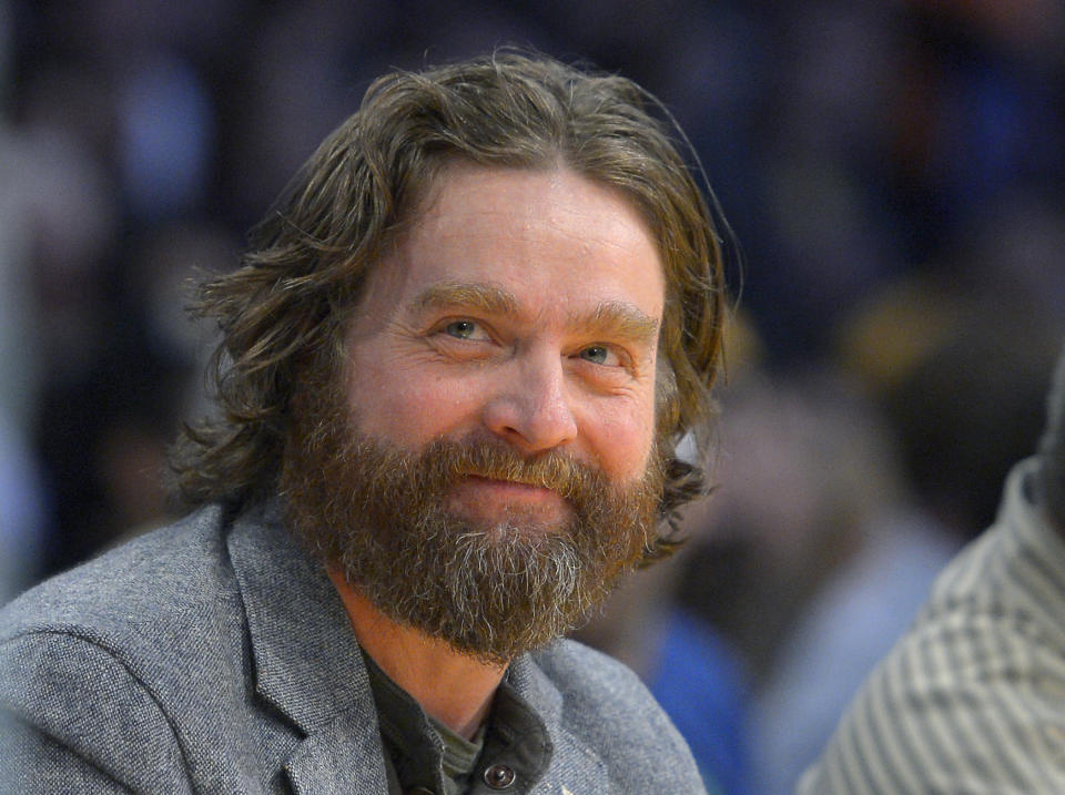 FILE - In this Feb. 28, 2013 file photo, actor Zach Galifianakis watches the Los Angeles Lakers play the Minnesota Timberwolves in their NBA basketball game in Los Angeles. President Barack Obama is hamming it up online to promote his health care plan. Obama joked Tuesday with Galifianakis, including poking fun at the poorly reviewed "Hangover Part III" during an interview on thhe website Funny or Die. (AP Photo/Mark J. Terrill, File)