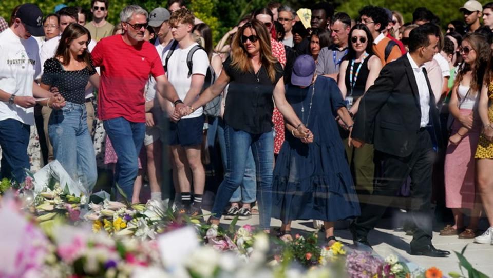 Family of Nottingham victims lay flowers at vigil attended by thousands (PA)