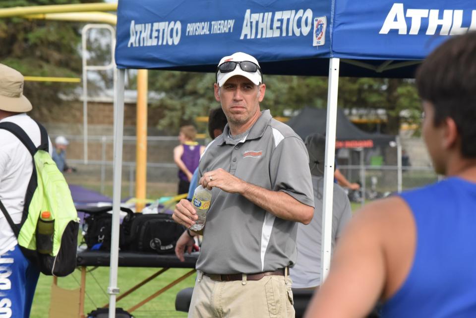 Tecumseh track and field coach Wes Harden watches on during the Lenawee County Track and Field Championships at Onsted.