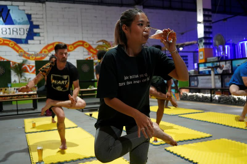 Sreyline Bacha participates in a beer yoga session, as the country eases COVID-19 restrictions, at a craft brewery in Phnom Penh