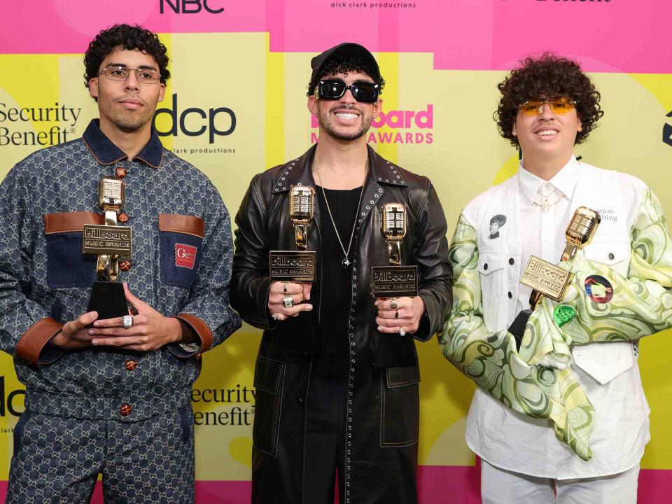 <p>Rich Fury/Getty</p> Bad Bunny with his siblings, Bysael and Bernie Marti­nez Ocasio, backstage at the 2021 Billboard Music Awards in May 2021 in Los Angeles, California. 