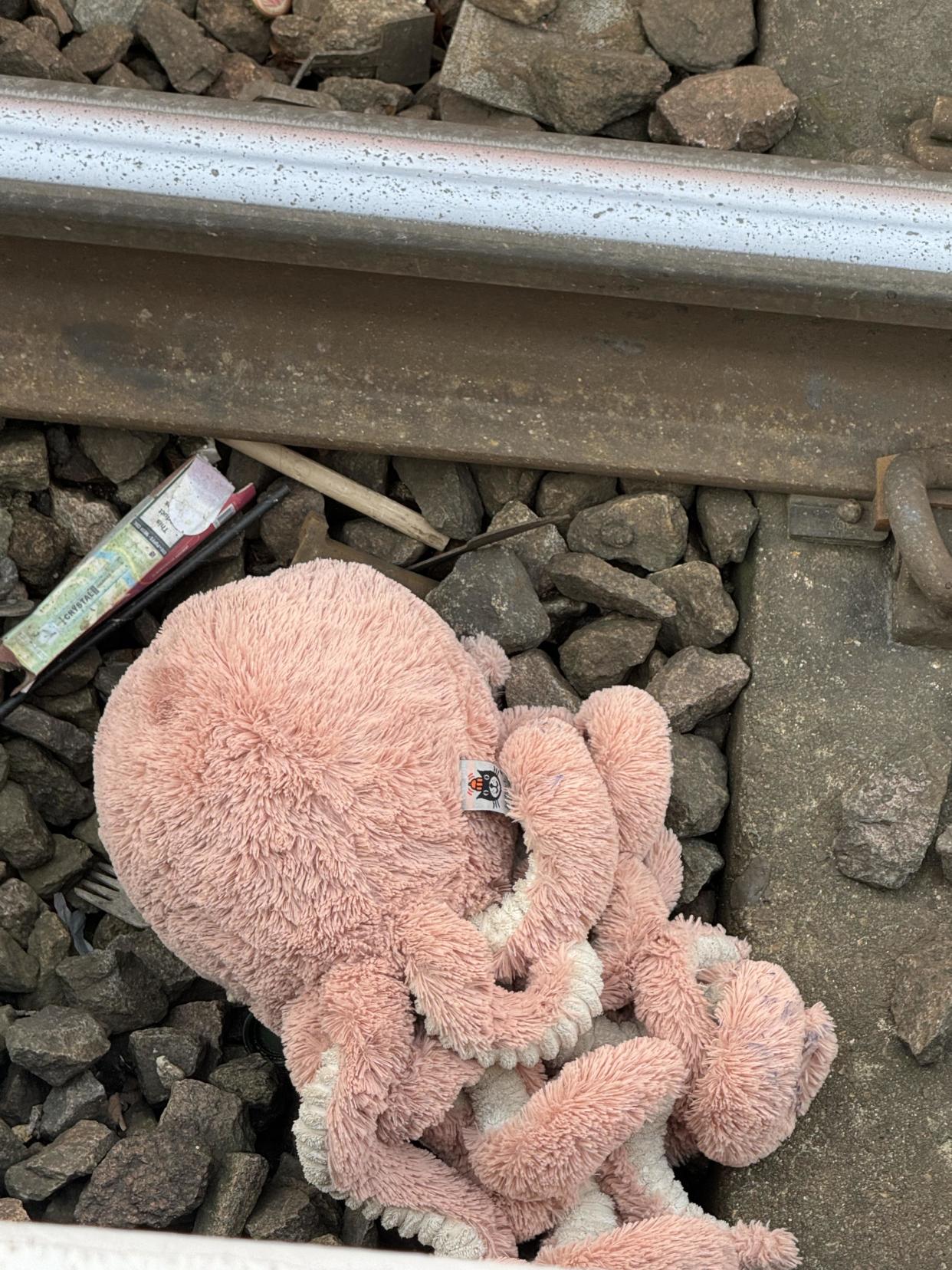 Toy octopus on train tracks 