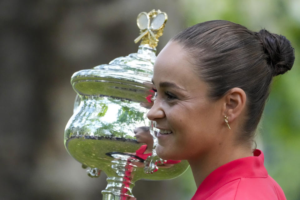 FILE - Ash Barty of Australia poses with the Daphne Akhurst Memorial Cup at a park, the morning after defeating Danielle Collins of the U.S. in the women's singles final at the Australian Open tennis championships in Melbourne on Jan. 30, 2022. In a shock announcement Wednesday, March 23, 2022, No. 1-ranked Barty announced her retirement from tennis. (AP Photo/Mark Baker,File)