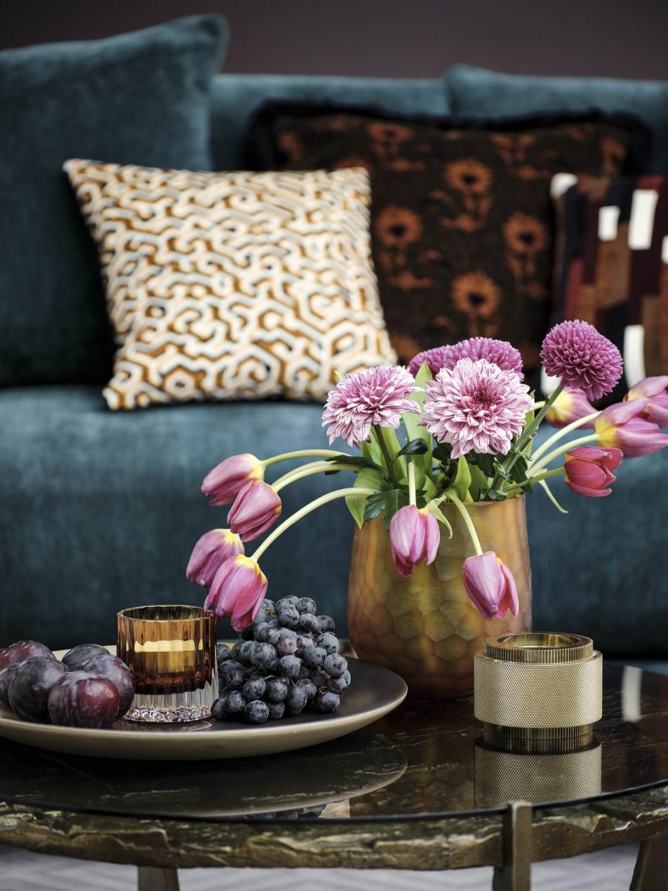 a table with flowers and a vase of flowers