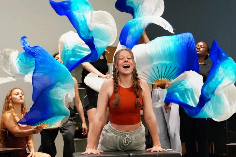 Josslyn Shaw as Ariel is surrounded by actors creating waves around her during a rehearsal for Area Stage Company’s “Little Mermaid.