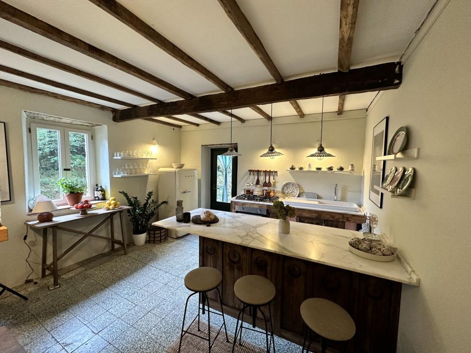 a kitchen with a bar and stools