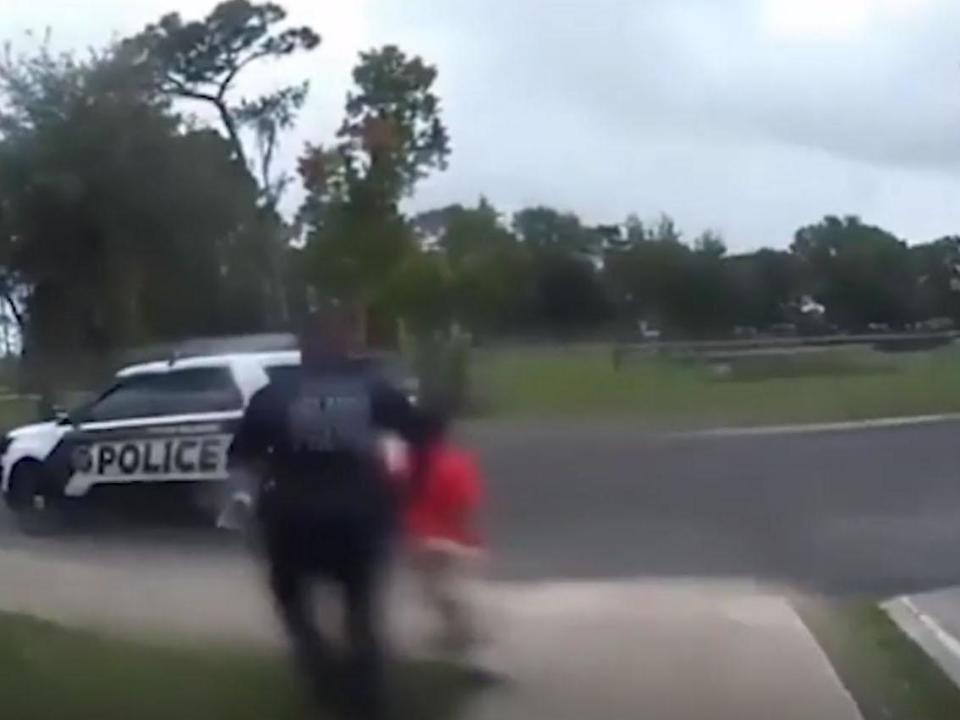 The 6-year-old begs was led out to a patrol car as she pleaded with the officer: Orlando Police Department