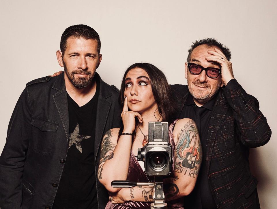 Elvis Costello (far right) poses with producer Sebastian Krys and singer Nina Diaz. Krys produced "Spanish Model," a reworking of Costello's album, "This Year's Model," while Diaz sings "No Action" on the new release.