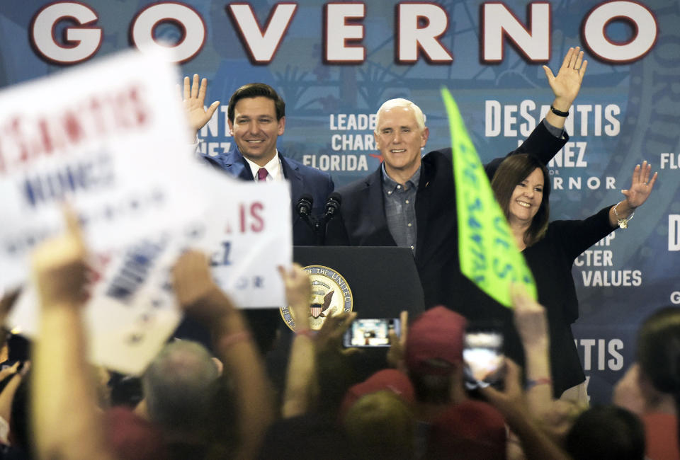 FILE- IN This Oct. 25, 2018 file photo Florida Republican gubernatorial candidate Ron DeSantis waves to the crowd at his Jacksonville, Fla., campaign rally where he was joined by Vice President Mike Pence and his wife Karen Pence. In the past, Florida's top races were tug-of-wars over taxes and education and insurance. This time around the governor's race is a proxy battle between President Donald Trump, who brought GOP gubernatorial nominee DeSantis to prominence and Democrats who oppose him. (Bob Self /The Florida Times-Union via AP, File)