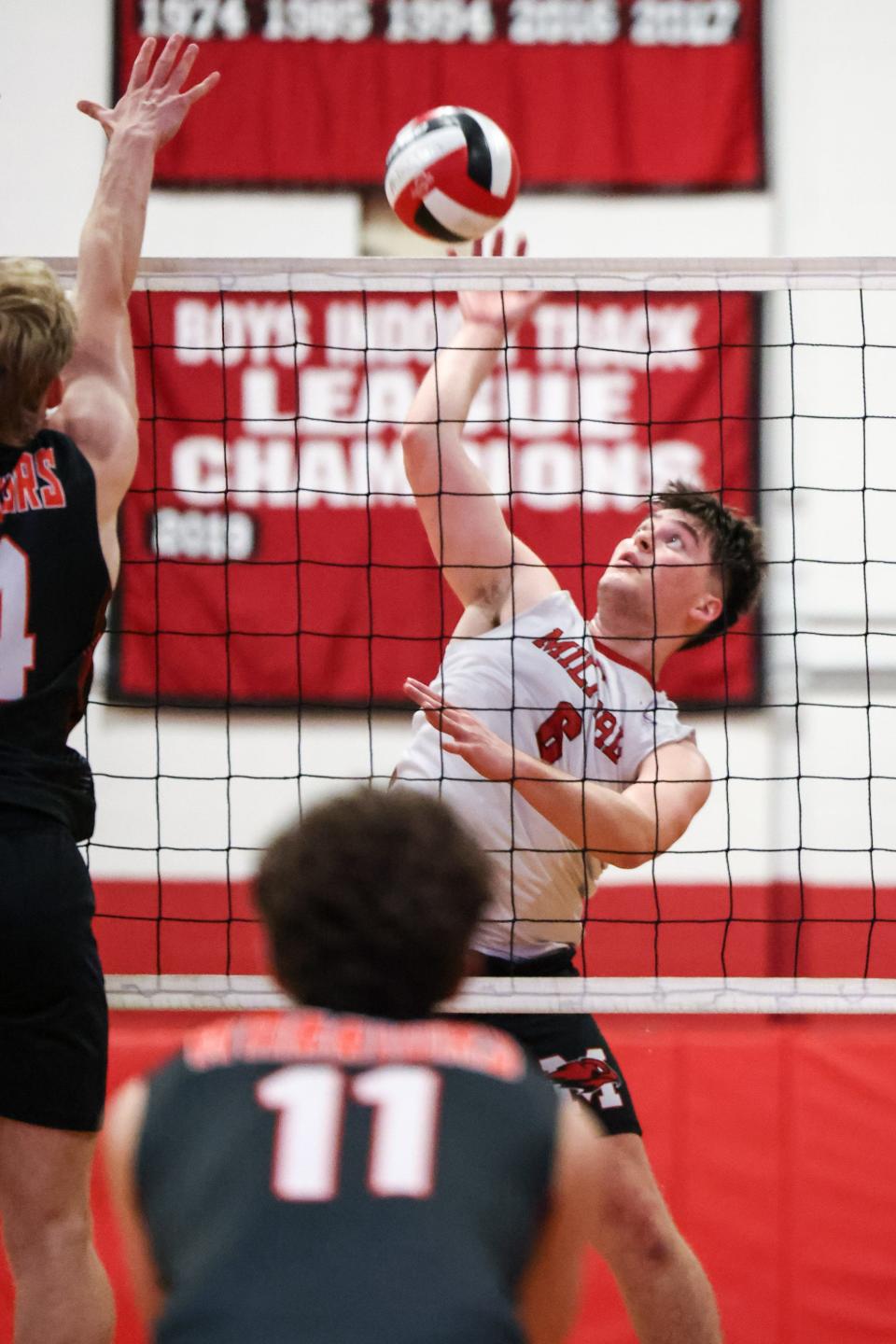 Milford’s Arthur Gomes goes up for the kill during the Round of 16 playoff game against Wayland at Milford High School on Jun. 07, 2023.