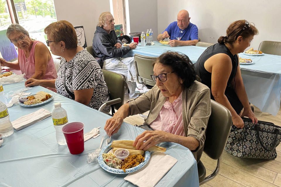 Seniors at the American Indian Center of Chicago enjoy a contemporary Indigenous meal of turkey tamales with cranberry-infused masa, Spanish rice with quinoa, and elote pasta salad with chickpea noodles prepared by Ketapanen Kitchen executive chef Jessica Pamonicutt, in Chicago, on Aug. 3, 2022. (Claire Savage/Report for America via AP)