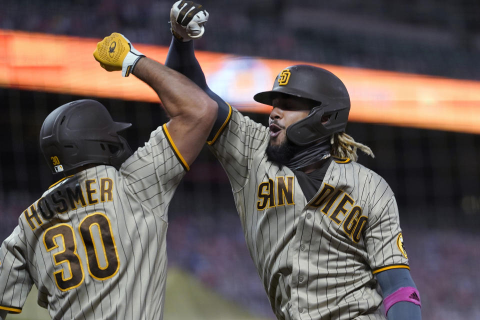 San Diego Padres' Fernando Tatis Jr., right, is congratulated by Eric Hosmer after hitting a solo home run against the San Francisco Giants during the fourth inning of a baseball game in San Francisco, Saturday, Sept. 26, 2020. (AP Photo/Eric Risberg)