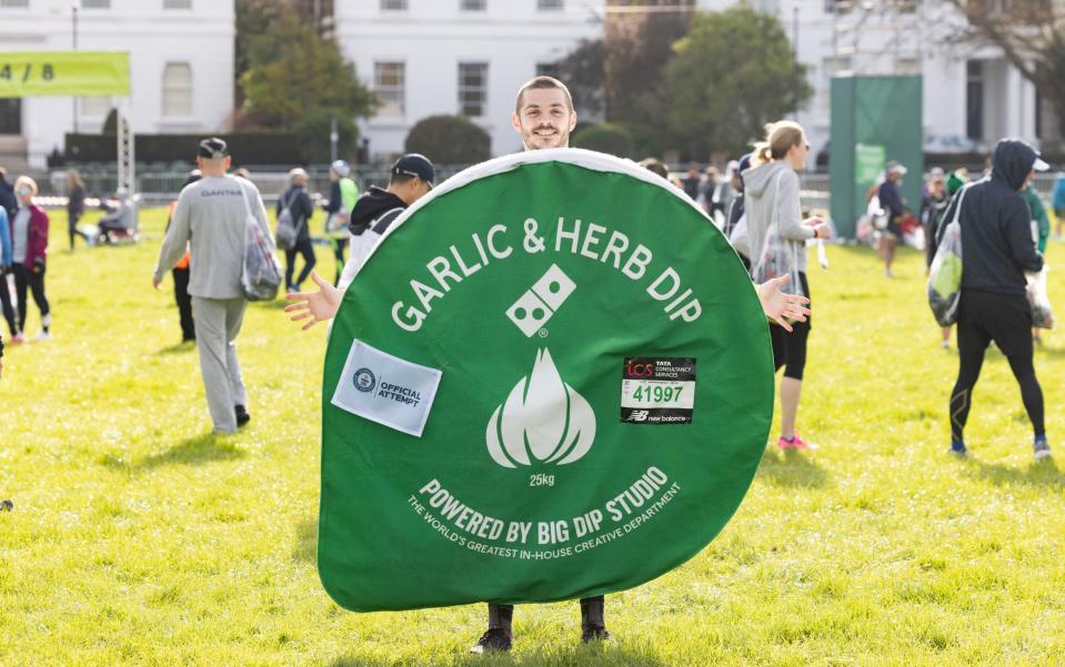 Jack Glasscock at Greenwich Park as he prepares to run the London Marathon dressed as a Domino's Pizza 'Garlic and Herb dip', in aid of Teenage Cancer Trust - PA