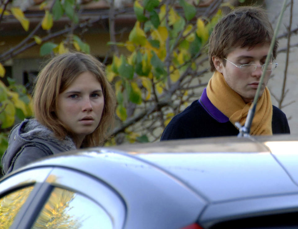 FILE - In this Friday Nov. 2, 2007 file photo Amanda Knox, left, and Raffaele Sollecito, stand outside the rented house where 21-year-old British student Meredith Kercher was found dead Friday, in Perugia, Italy. An appeals court in Florence has upheld the guilty verdict against U.S. student Amanda Knox and her ex-boyfriend for the 2007 murder of her British roommate. Knox was sentenced to 28 1/2 years in prison, raising the specter of a long legal battle over her extradition. After nearly 12 hours of deliberations Thursday, Jan. 30, 2014 the court reinstated the guilty verdict first handed down against Knox and Raffaele Sollecito in 2009. (AP Photo/Stefano Medici)