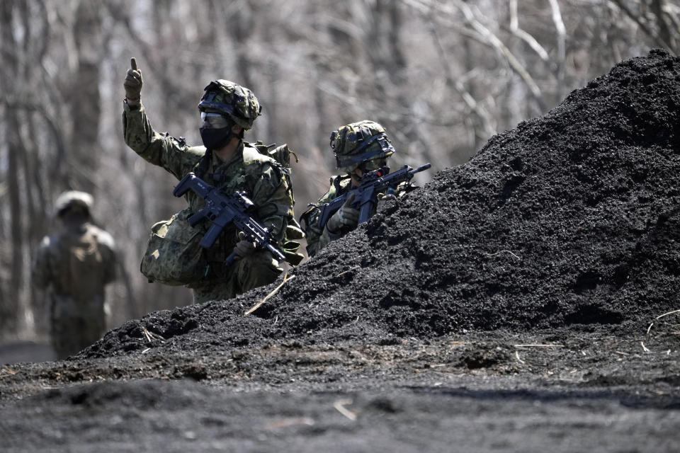 Members of the Japan Ground Self-Defense Force (JGSDF) take part in a joint military helicopter borne operation drill between JGSDF and U.S. Marines at the Higashi Fuji range in Gotemba, southwest of Tokyo, Tuesday, March 15, 2022. (AP Photo/Eugene Hoshiko)