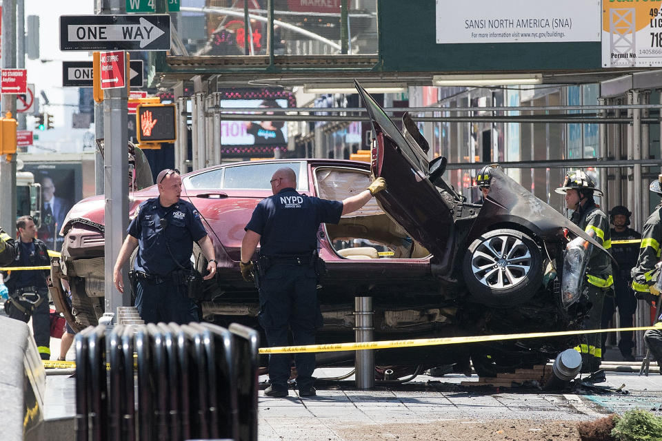 <p>A wrecked car sits in the intersection of 45th and Broadway in Times Square, May 18, 2017 in New York City. According to reports there were multiple injuries and one fatality after the car plowed into a crowd of people. (Photo: Drew Angerer/Getty Images) </p>