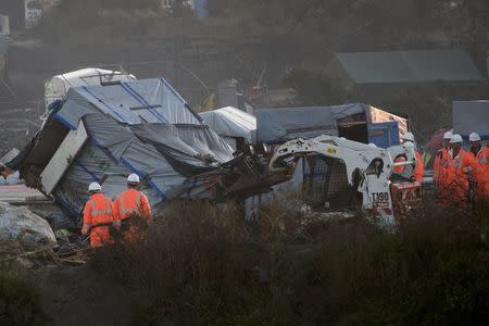 A bulldozer is used to remove a makeshift shelter during the dismantlement of the camp called the "Jungle" in Calais, France, October 27, 2016. REUTERS/Philippe Wojazer